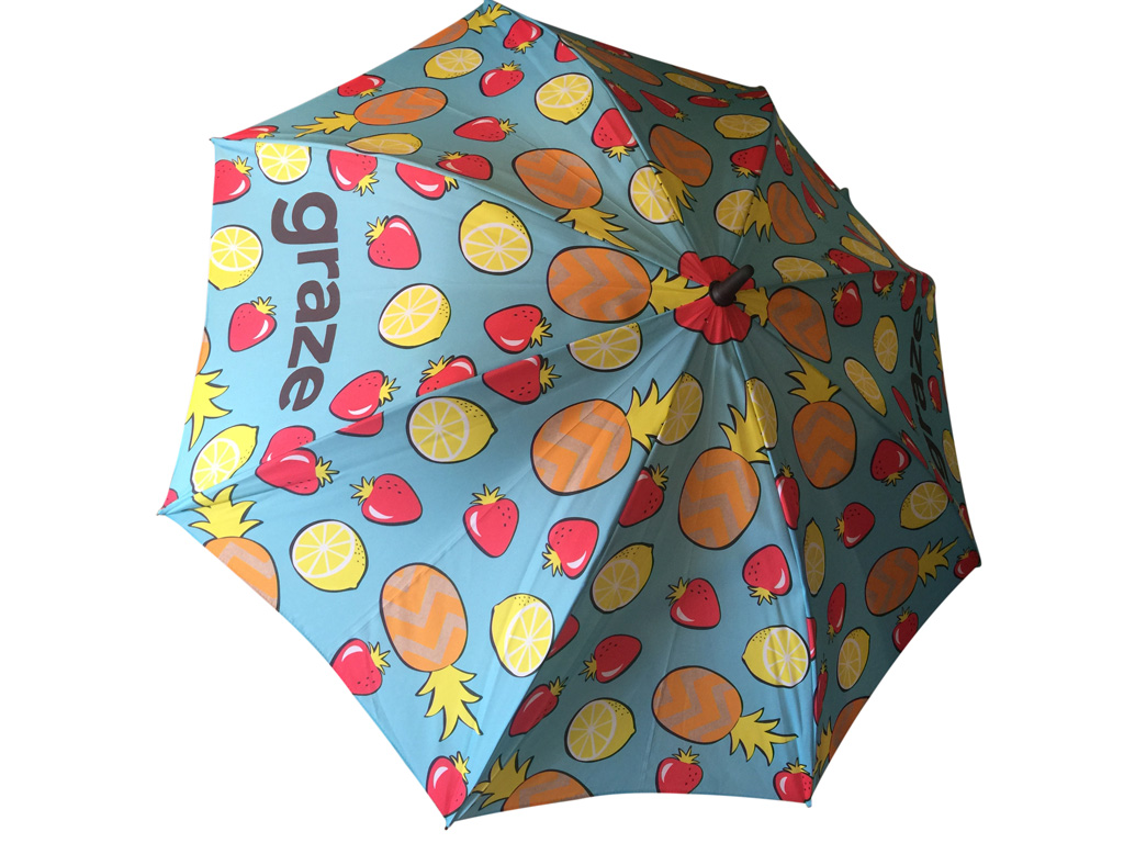 brightly printed umbrella with fruit graphics