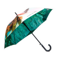 side view of walking umbrella with green print on inside and abstract pattern on outside umbrella panels