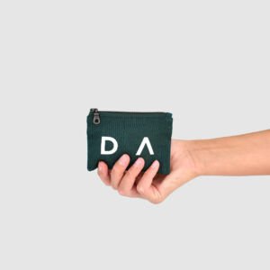 Hand holding a rectangular shape green zip bag with white letters D A