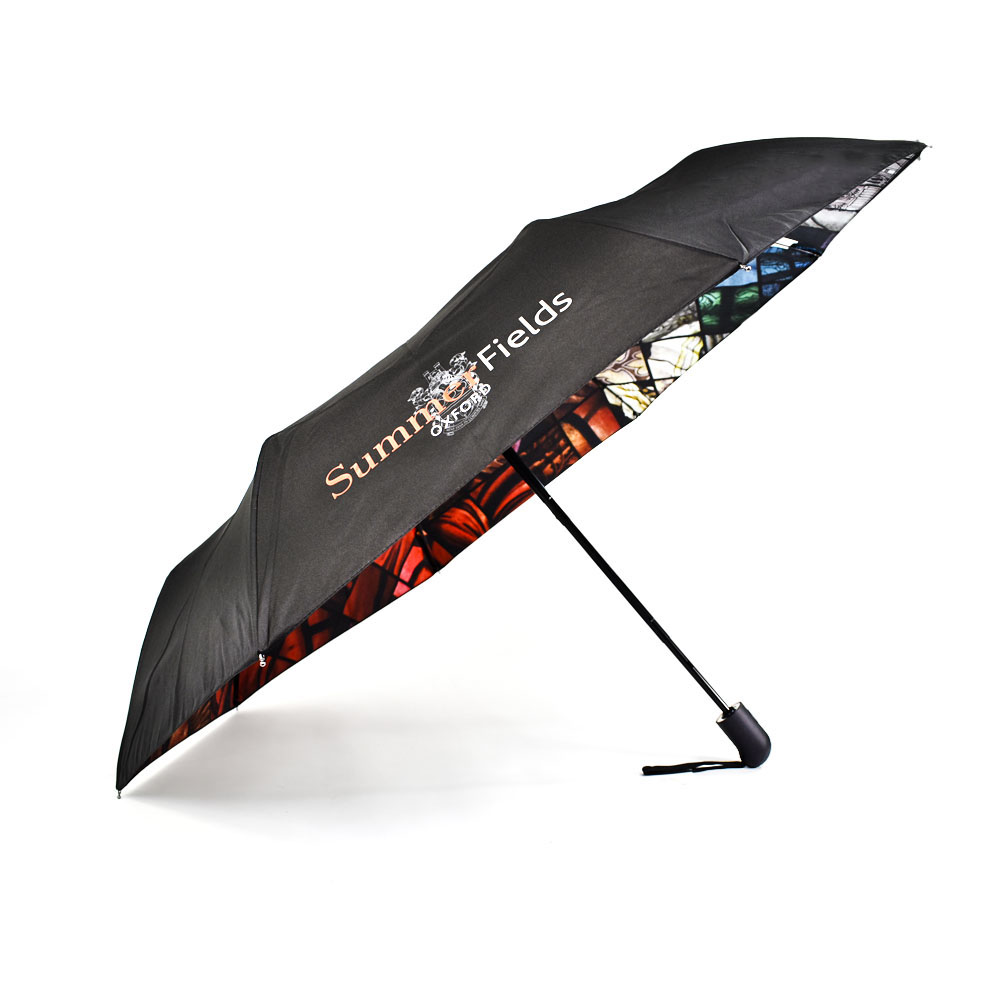 open umbrella on the side with stained glass window print on inside of umbrella