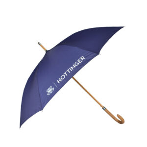 Purple umbrella open on and displayed leaning on the side with wooden pole and handle