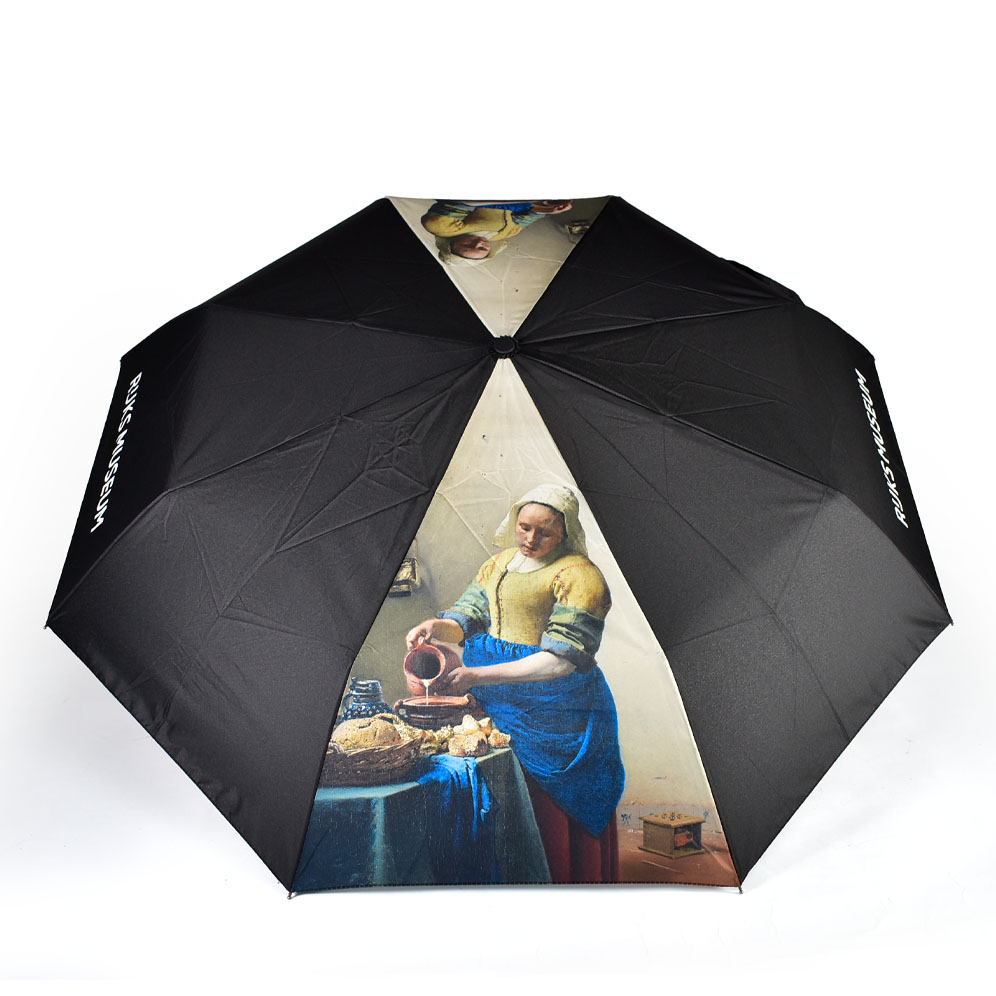 Open umbrella with six black panels and two fine art prints of a woman on two panels. The umbrella is open and is viewed from the top