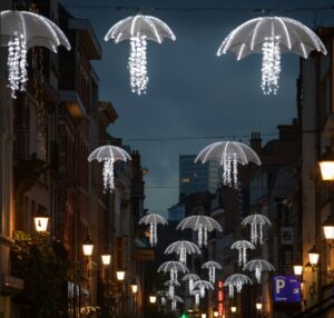 Umbrella shapes as LED lights hanging from the sky in a dark city street