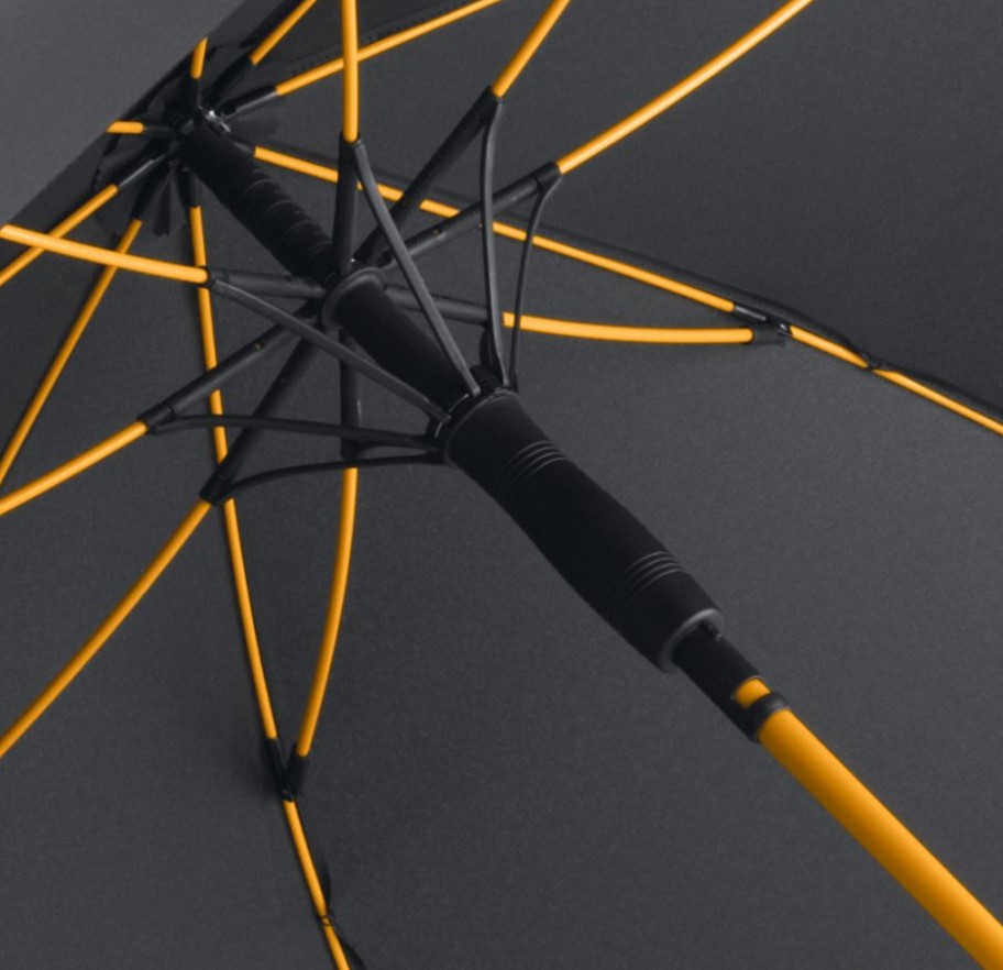 inside of black panel umbrella showing orange umbrella frame and pole