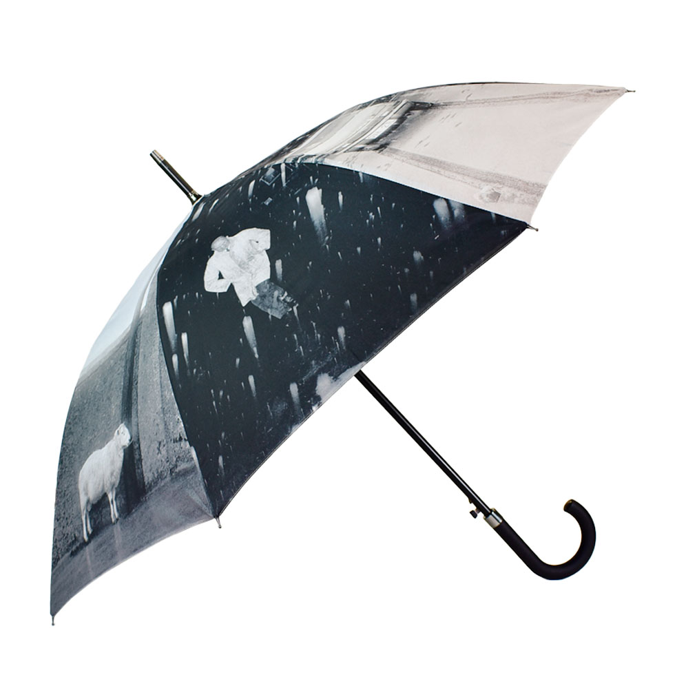 open umbrella on the side with black and white photo prints