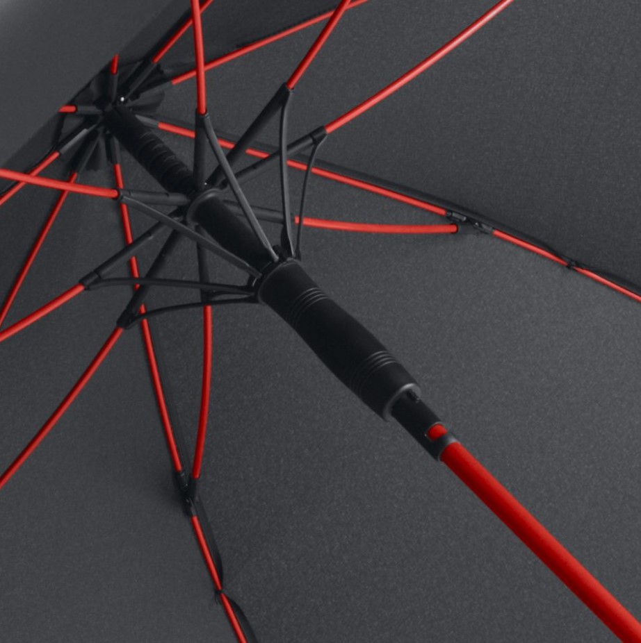 inside of black panel umbrella showing red umbrella frame and pole