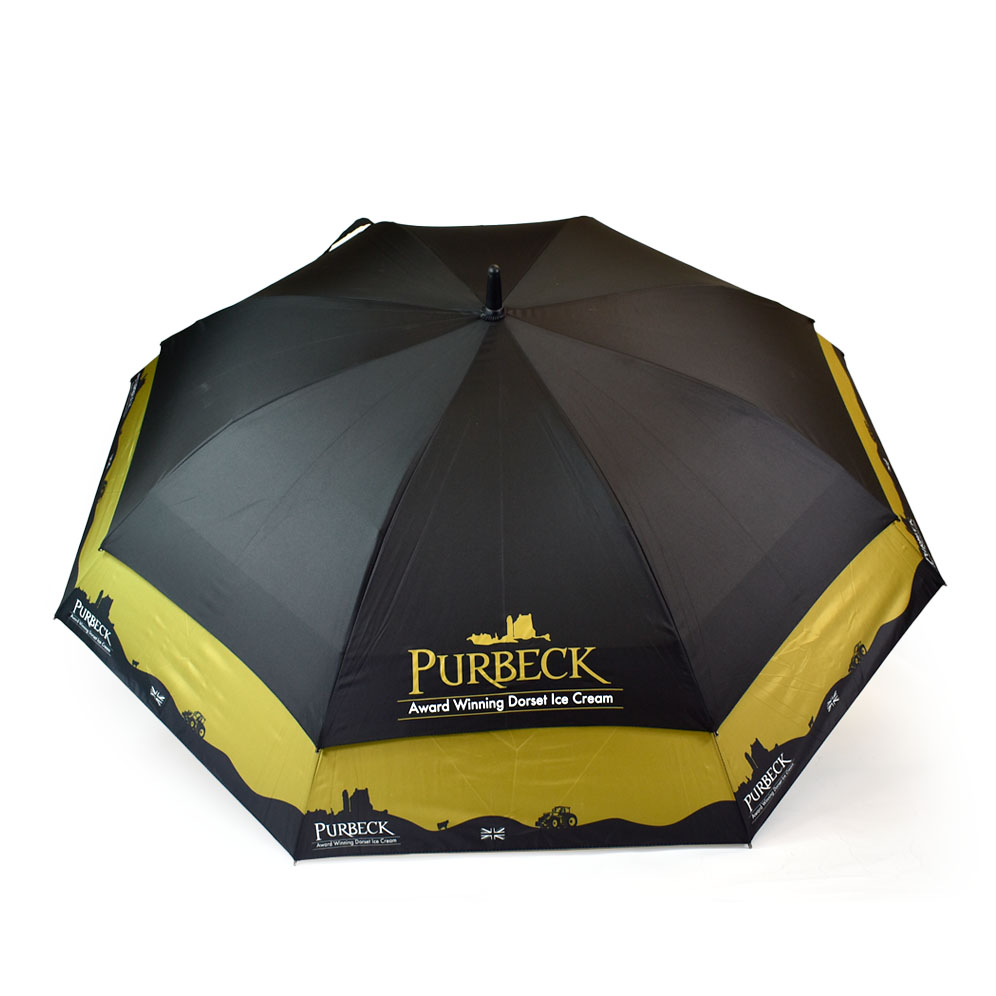 vented umbrella printed yellow and black with skyline around the bottom of the umbrella panels with PURBECK ice cream logo printed on it